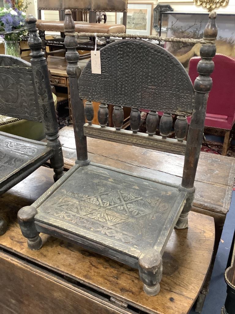 Two African carved hardwood seats, width 49cm, depth 39cm, height 64cm